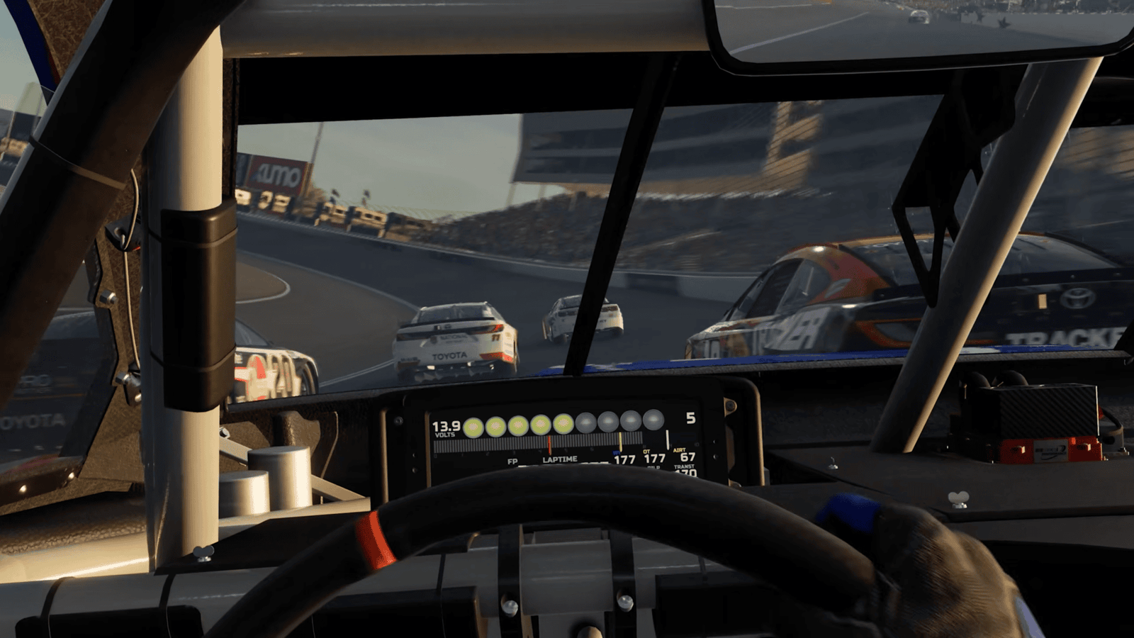NASCAR 26 cockpit view at a road course showing Toyota Cup Series cars ahead with Kumo tire branding visible on the track surroundings