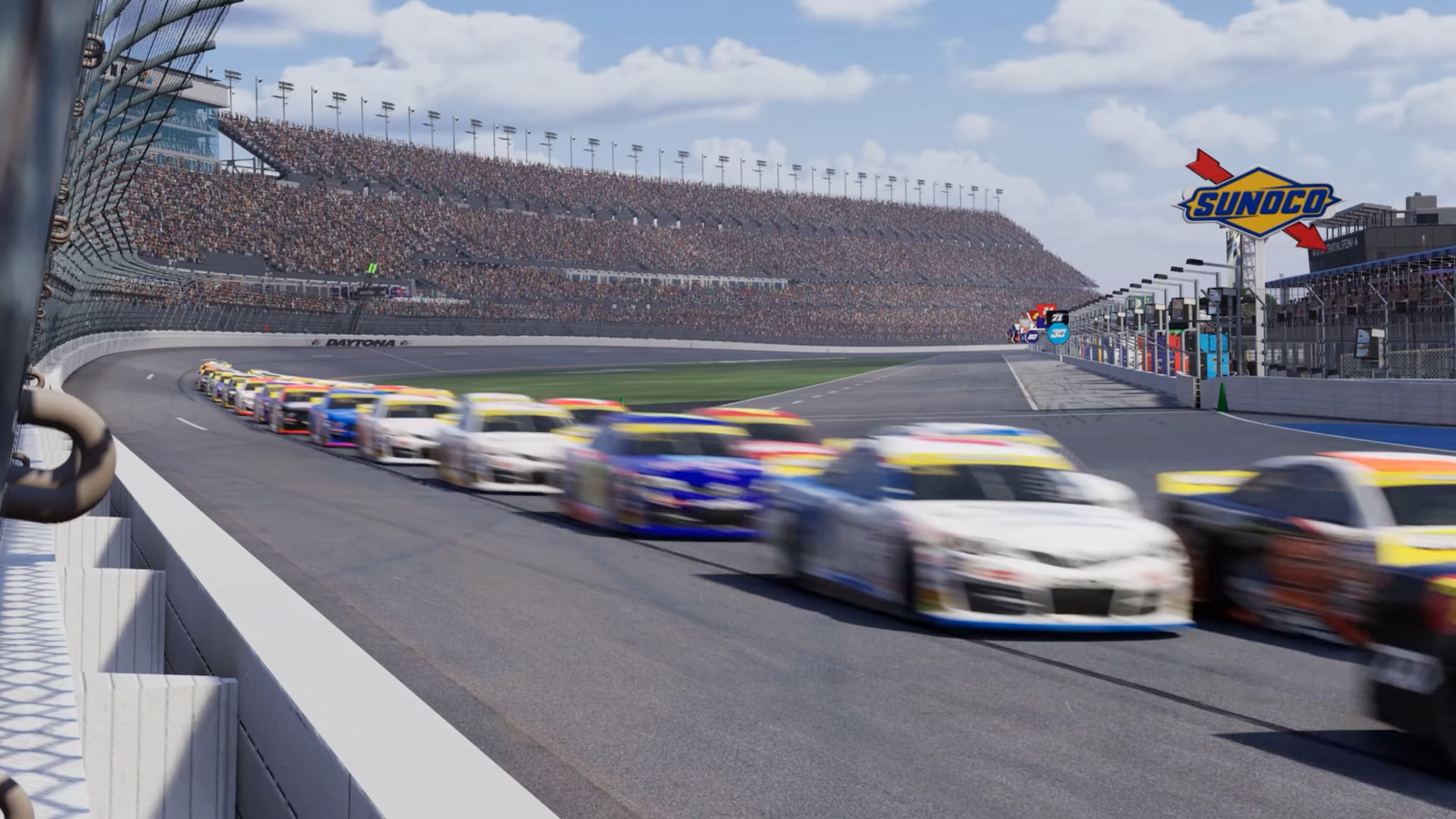 NASCAR 26 gameplay showing a massive drafting pack of Cup Series cars at Daytona International Speedway with the iconic Sunoco fuel sign visible